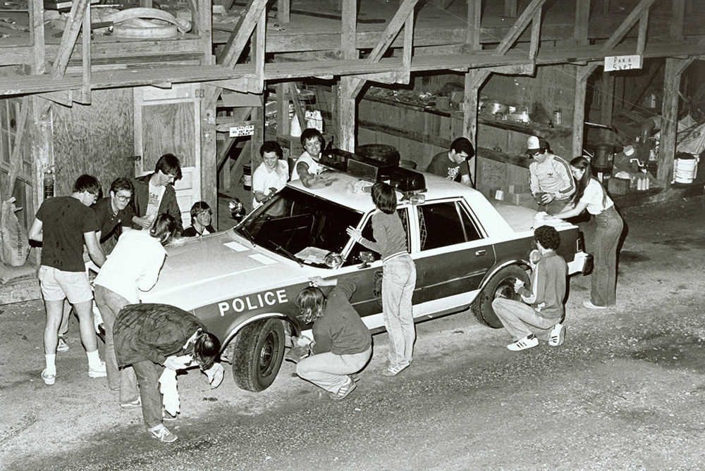 Students washing police car during Big Event at Texas A&M